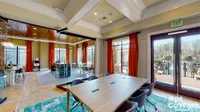 Apt CoWork at Heights at Meridian Apartments Modern coworking space at Heights at Meridian featuring a glass-enclosed meeting room, elegant decor, and expansive outdoor views.