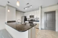Kitchens with Breakfast Bars Contemporary kitchen at Heights at Meridian Apartments with sleek granite countertops, stainless steel appliances, and elegant pendant lighting.