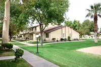 Charming apartment complex surrounded by lush greenery and well-maintained pathways, offering a tranquil living environment at Camelot Apartments in Yuma AZ