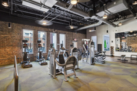 The Melrose Apartments Fitness Center in South Nashville Chic industrial-style fitness center with modern equipment and exposed brick walls, offering a dynamic workout environment at The Melrose Apts in South Nashville.