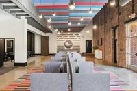 Dynamic Apt CoWork Space at The Melrose Modern co-working space with vibrant decor, stylish seating, and exposed brick walls, perfect for collaboration and creativity at The Melrose Apartments.