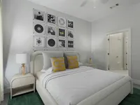 Welcoming bedroom at The Melrose Apartments in South Nashville, featuring direct access to a spacious bathroom and a walk-in closet. Modern bedroom with elegant decor, featuring a cozy bed, artistic wall art, and a private ensuite bathroom at The Melrose Apts in South Nashville.
