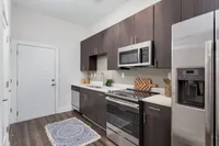 Inviting Studio Kitchen at The Melrose Apts in Berry Hill, TN. Modern kitchen with sleek dark wood cabinetry, stainless steel appliances, and an elegant countertop at The Melrose Apts in Berry Hill, TN.