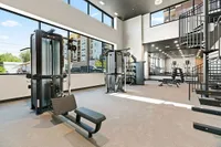 Two Story Fitness Center with Spin Bikes, Free Weights, Cardio Machines, and Strength-Training Machines