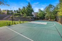 Basketball and Sport Court Inviting outdoor basketball court surrounded by lush greenery and a peaceful residential setting at Scott Mountain Apartments.