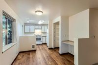 Classic Kitchen and Dining Room Bright, open kitchen at Scott Mountain Apartments with modern cabinetry and hardwood flooring.