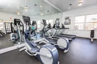 Stonebriar of Frisco's bright and modern gym featuring state-of-the-art elliptical machines and treadmills, perfect for a dynamic workout experience.