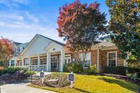 Inviting community clubhouse at Summer Park Apartments with charming brick exterior and lush landscaping, perfect for future residents.
