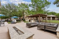 Toscana at Valley Ridge Pool Deck in Lewisville, Texas Inviting outdoor lounge with modern seating, shaded pergola, and lush green surroundings, perfect for relaxing and entertaining at Toscana at Valley Ridge Apartments.