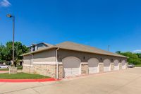 Garage and Covered Parking Toscana at Valley Ridge Apartments with spacious garages and ample parking, surrounded by lush greenery and clear blue skies.