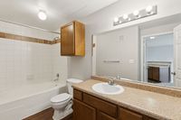 Bathroom at Toscana at Valley Ridge Elegant bathroom with sleek vanity, modern lighting, and classic tile design for sophisticated living at Toscana at Valley Ridge Apartments in Lewisville, Texas.