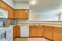 Kitchens with Breakfast Bars Inviting kitchen at Toscana at Valley Ridge Apartments with warm wooden cabinets, sleek countertops, and modern appliances.