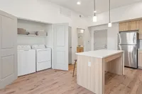 Kitchen and Laundry Room at Current Apartments