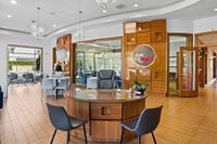 Coworking Space at Marq Highland Park at Apt Cowork Tampa, FL Modern co-working space with stylish wooden decor, round desk, and ample natural light, perfect for productivity at the Marq Highland Park Apt CoWork in Westchase Tampa
