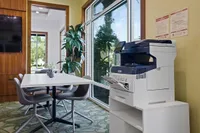 The Marq at Highland Park's Print Station at Apt CoWork in Westchase Tampa Bright and modern business center with a spacious meeting table, sleek gray chairs, and a high-tech multifunction free printer at the Marq Highland Park Apt CoWork in Westchase Tampa