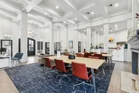 Elegant co-working space with high ceilings, plush seating, and modern decor, perfect for productivity and collaboration at Stonebriar at Frisco Apartments