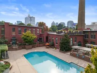 Pool with City Skyline Alpha Mill Apartments in NODA Charlotte, NC