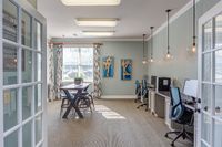 Bright and modern office space at The Stratford at Hillcrest Towne Center Apartments with stylish decor, natural light, and a collaborative work environment.