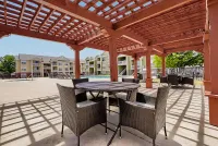 Shaded outdoor seating under our pergola here at The Orchards at Cherry Creek Park Apartments
