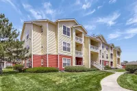 Charming multi-story apartment complex with fresh landscaping and vibrant exterior in a serene neighborhood in Centennial, Colorado.