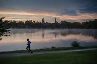Walking Trails Nearby Pond with runner and Notre Dame in background
