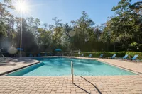Experience relaxation and leisure by this stunning outdoor pool, perfect for sunny days.