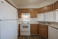 Step into culinary delight with this charming kitchen, featuring modern amenities and classic wooden finishes.