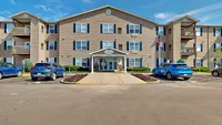 Inviting residential building with modern design, beautifully landscaped entrance, and convenient parking.