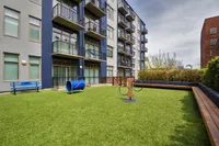 On-site dog park with agility features and seating