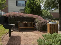 Quiet grilling nook surrounded by lush greenery