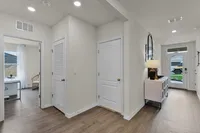 Inviting entryway with wood-style flooring and modern finishes.