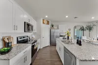Fully equipped kitchen with granite countertops and sleek finishes.