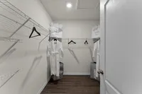Walk-in closet with ample shelving and storage space.