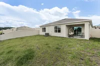 Spacious backyard with covered patio—perfect for lounging or entertaining.