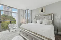 Bedroom with floor-to-ceiling windows and city views