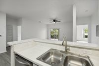 interior pic of deluxe kitchen unit with gray planking and white walls, stainless steel appliances and backsplash