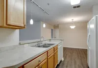 Modern kitchen with bar seating and pendant lighting.
