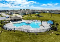 Resort-style pool with splash feature, cabana, and plenty of room to unwind.