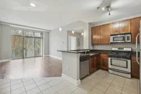 Open-concept kitchen with stainless steel appliances and bar counter