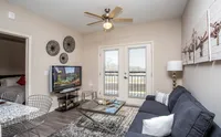 Cozy living area with private balcony access and plenty of natural light.