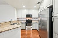 Remodeled kitchen with sleek stainless steel appliances, elegant cabinetry, and polished granite countertops for a stylish cooking experience.