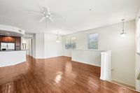 Bright and spacious open-concept living area with modern kitchen, featuring sleek hardwood floors and abundant natural light.