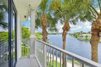 Refreshing balcony views showcasing lush palm trees and serene waterfront vistas, perfect for relaxation.