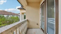 Charming balcony with elegant railing offering a scenic view and abundant natural light, ideal for relaxation.