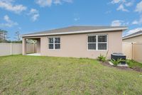 Charming single-story home with a large backyard, privacy fence, and modern exterior, perfect for outdoor enjoyment.