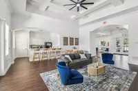 Spacious open-concept living area with modern kitchen, elegant seating, and bright natural light.
