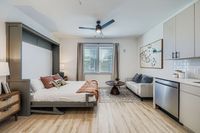 Charming studio apartment options featuring a stylish Murphy bed, cozy seating area, and modern kitchenette with natural light.