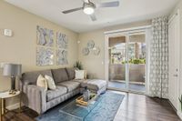 View of Living Room and Sliding Glass Door Leading to Shaded Patio