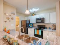 Gourmet kitchen, white cabinetry, hook-neck deep sink, granite countertops