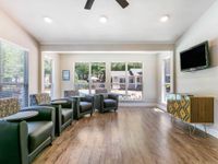 Community entertainment room with lounge chairs, and TV